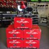Milwaukee 2733-21 M18 FUEL 7-1/4 dual bevel sliding compound miter saw on red packaging boxes in tool store